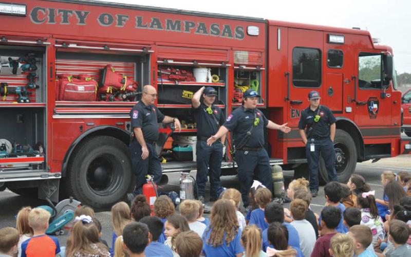 Lampasas Fire Department firefighters speak with students about fire safety during last Friday’s Hanna Springs Elementary School Safety Walk event. erick mitchell | Dispatch record