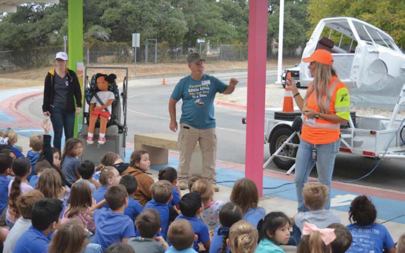 Texas Department of Transportation and Texas A&amp;amp;M AgriLife Extension representatives discuss car seat safety during last week’s Safety Walk at Hanna Springs Elementary School. erick mitchell | Dispatch record