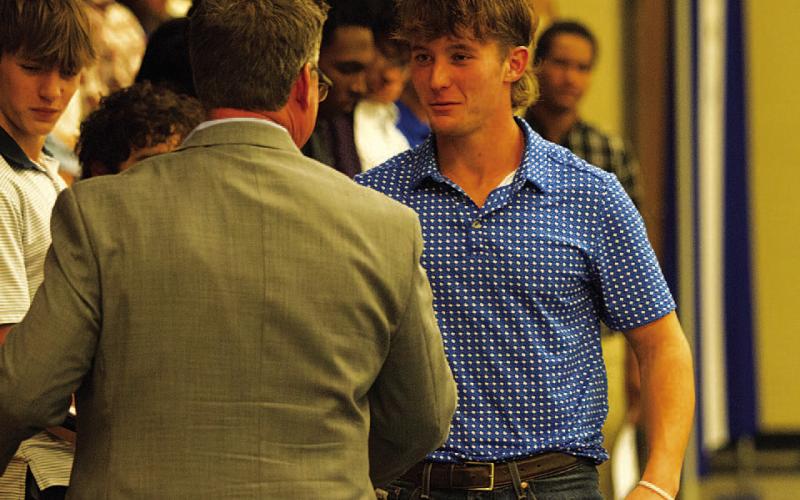 HUNTER KING | DISPATCH RECORD Reed Jerome receives the Battlin’ Badger award from head coach Troy Rogers.