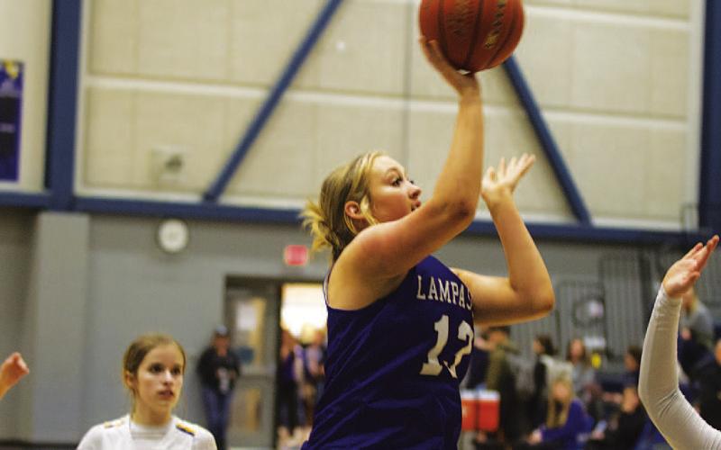 Keaton Owen shoots over a Lady Viking defender during Tuesday’s win. HUNTER KING | DISPATCH RECORD