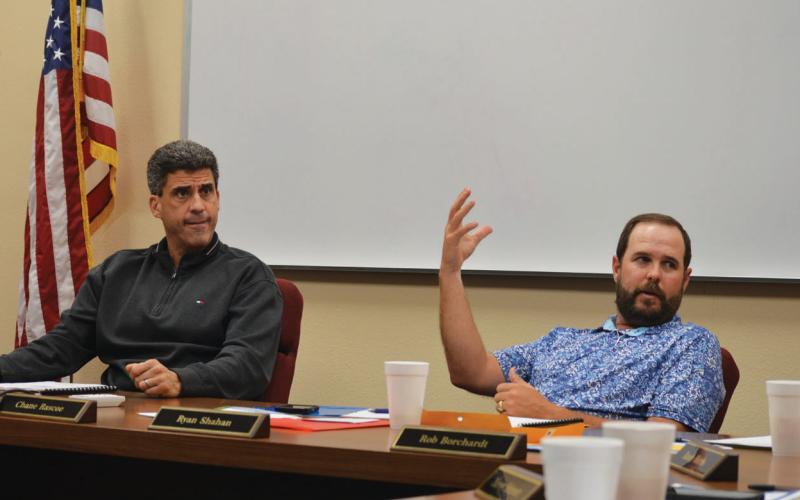 erick mitchell | dispatc h record Superintendent Dr. Chane Rascoe, left, and Lampasas ISD Board President Ryan Shahan discuss with trustees what they want to see with design plans from WRA Architects.