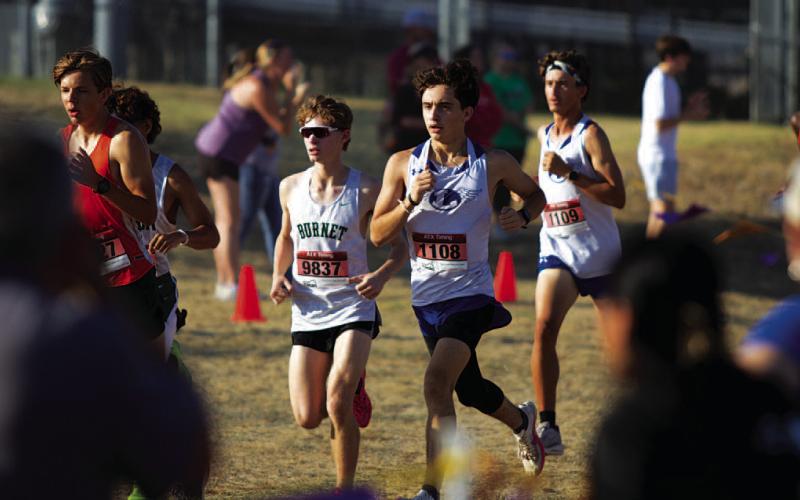 Royce Clary, left, and Tyler Ecker race around the trail during the district cross country meet. HUNTER KING | DISPATCH RECORD