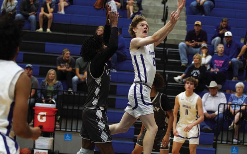 HUNTER KING | DISPATCH RECORD Peyton Sisson leaps to finsh a layup against Eastside Memorial out of Austin.
