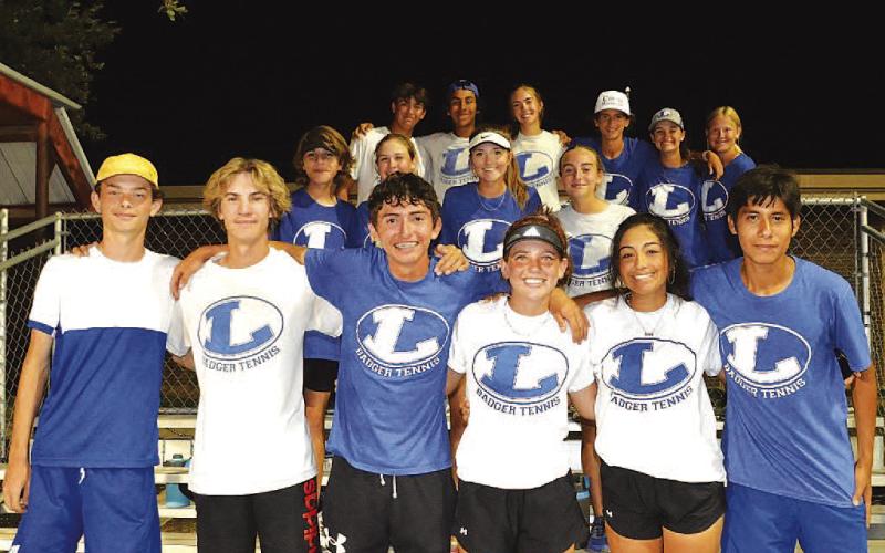 The tennis team poses for a photo after their dramatic victory last Friday night. COURTESY PHOTO