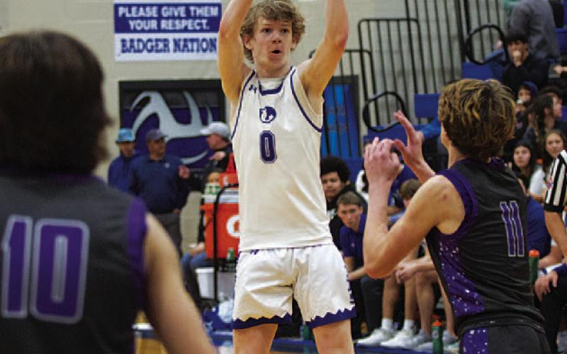 HUNTER KING | DISPATCH RECORD Peyton Sisson shoots over a defender for three of his 25 points Friday night.