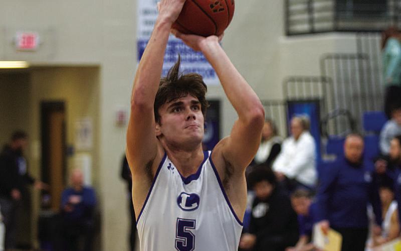 HUNTER KING | DISPATCH RECORD Trent Seneca shoots a free throw. The senior scored five points in the district contest.