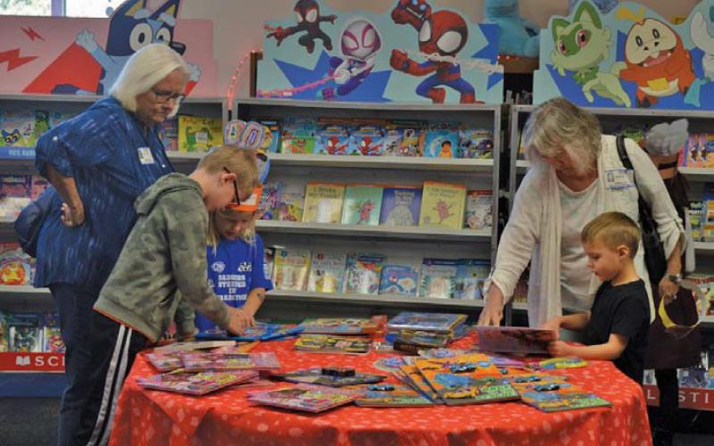 erick Mitchell | dispatch record These grandparents help their grandchildren find the perfect reading material at Hanna Springs Elementary School’s book fair, held last week.