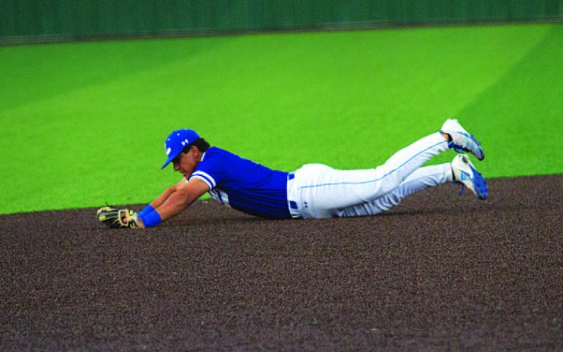 HUNTER KING | DISPATCH RECORD Eli Calderon dives to keep a ball in the infield.