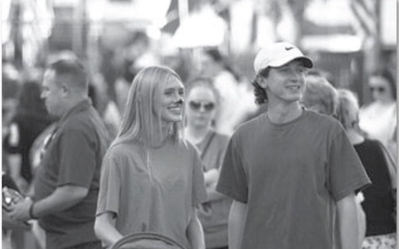 Leah Phillips, left, and Elijah Copeland smile as they walk around the square during the annual Squared Silly event last week. hunter king | Dispatch record