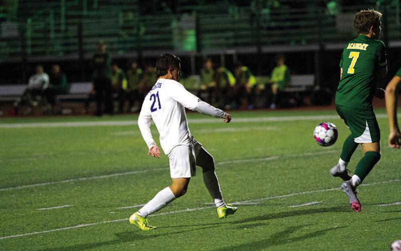 Juan Munoz picks out a pass to a teammate during the Badgers’ match against Academy. HUNTER KING | DISPATCH RECORD