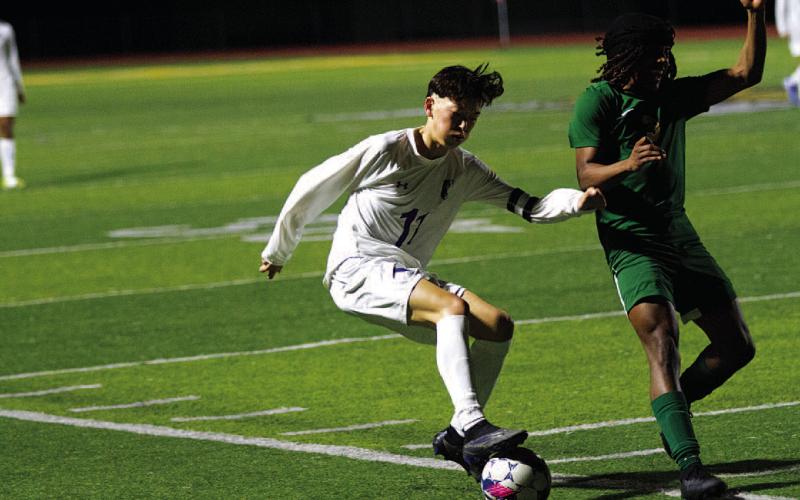 Kent Ashley fakes out a Bee defender during district action. HUNTER KING | DISPATCH RECORD