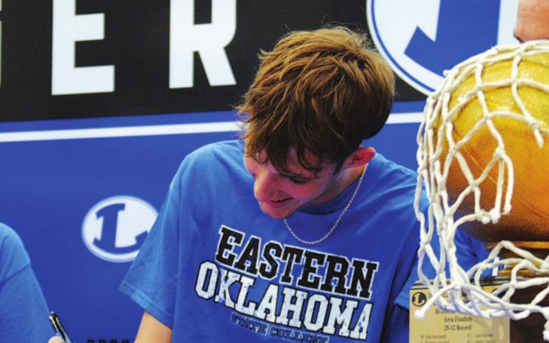 Kaeden Crawford signs his letter of intent to play basketball at the next level. HUNTER KING | DISPATCH RECORD