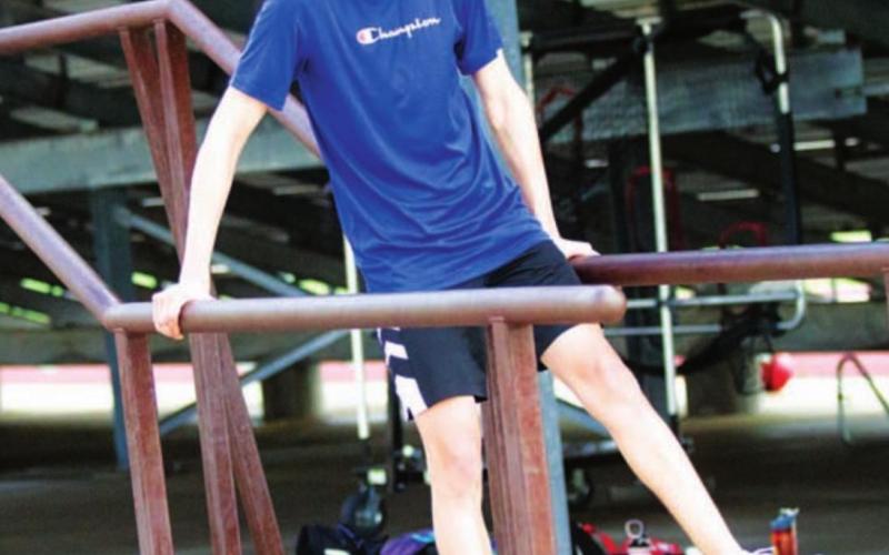 Luke Shivers works on the parallel bars during SWAT in the summer of 2021. FILE PHOTO