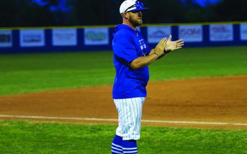HUNTER KING | DISPATCH RECORD Coach Chance Evans claps as his team bats late in last week’s district ball game.