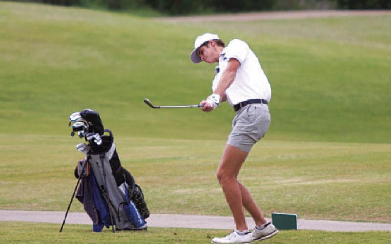 Vincent Shahan hits a pitch shot on day one of the district tournament in Kingsland. HUNTER KING | DISPATCH RECORD