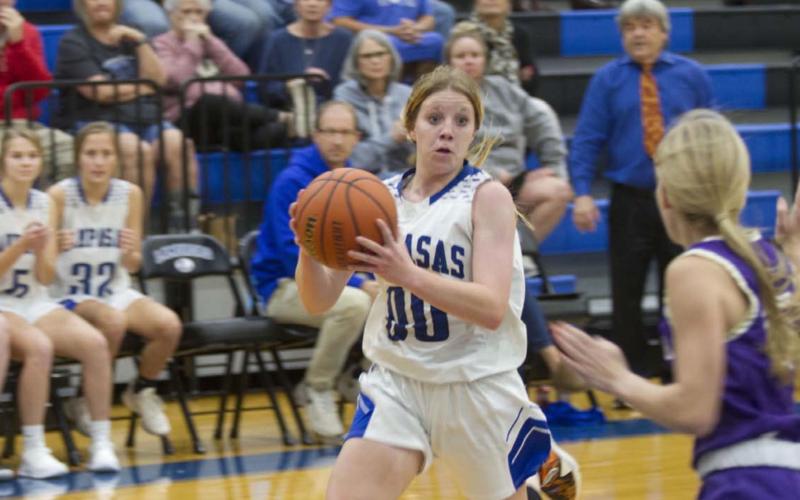 Aspen Wheeler drives toward the bucket against a Marble Falls defender on her way to completing an and-one basket to put the Badgers up by two points late in Tuesday’s game. HUNTER KING | DISPATCH RECORD