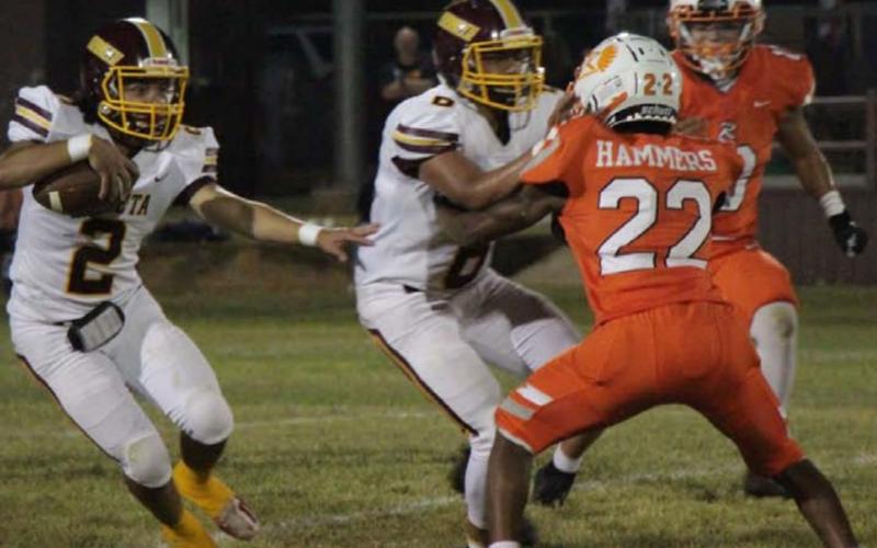 Tim Juarez runs past a Rotan defender while Luis Hernandez lays a block during the Hornets’ win last Friday. JESSICA MALDONADO | DISPATCH RECORD