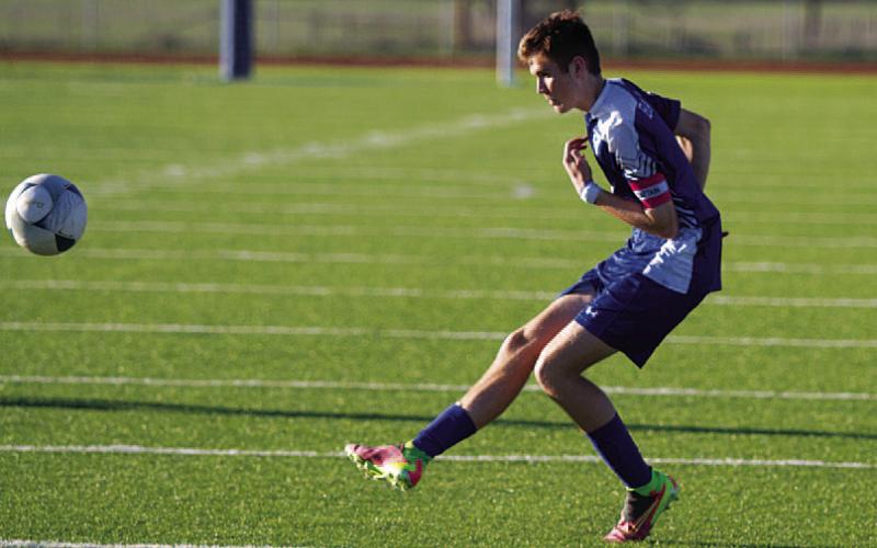 HUNTER KING | DISPATCH RECORD Keaton Black hits a free kick from outside the penalty box.