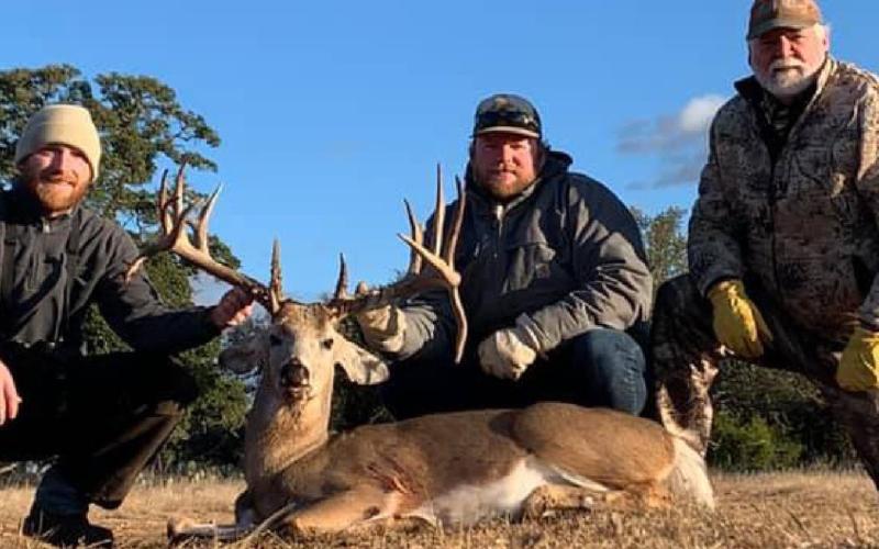 Tye Vann, Logan Vann and Kim Vann show a buck with double drop-tines that Logan Vann killed this season near Naruna. COURTESY PHOTO