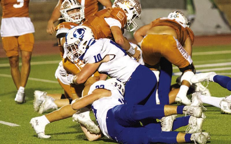 Brock Langford (10) and Levi Guthrie (33) tackle the Alice quarterback short of the goal line. HUNTER KING | DISPATCH RECORD
