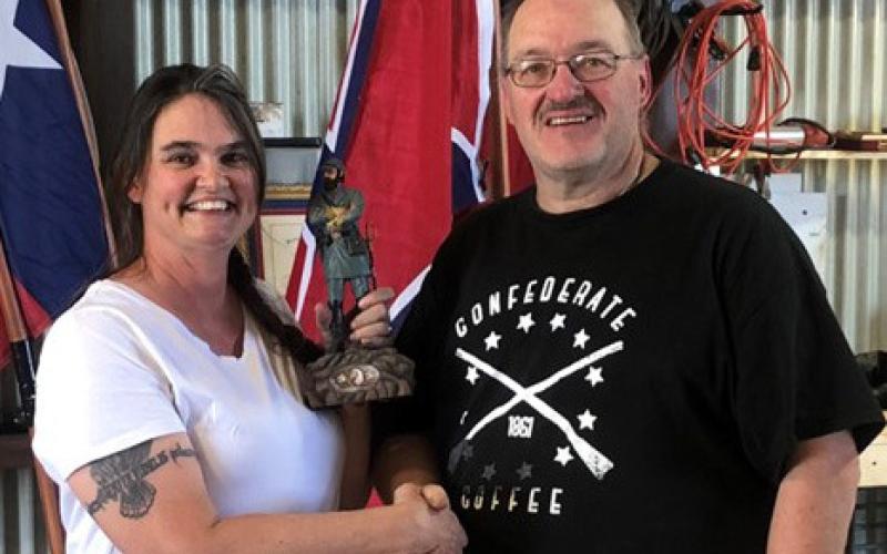 Sons of Confederate Veterans Camp Commander Michael Oliver presents the first-place trophy, a statue of Stonewall Jackson, to Cheryl Ayers, winner of the Black Powder Turkey Shoot held May 3. Ayers is the wife of the SCV camp commander of the Williamson County Grays No. 502. She also is an expert seamstress who creates period uniforms and ladies dresses. courtesy photo