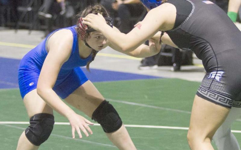Mia Martell, left, wrestles against a Burleson Centennial Lady Spartan on Friday at the state tournament in Cypress. JEFF LOWE | DISPATCH RECORD