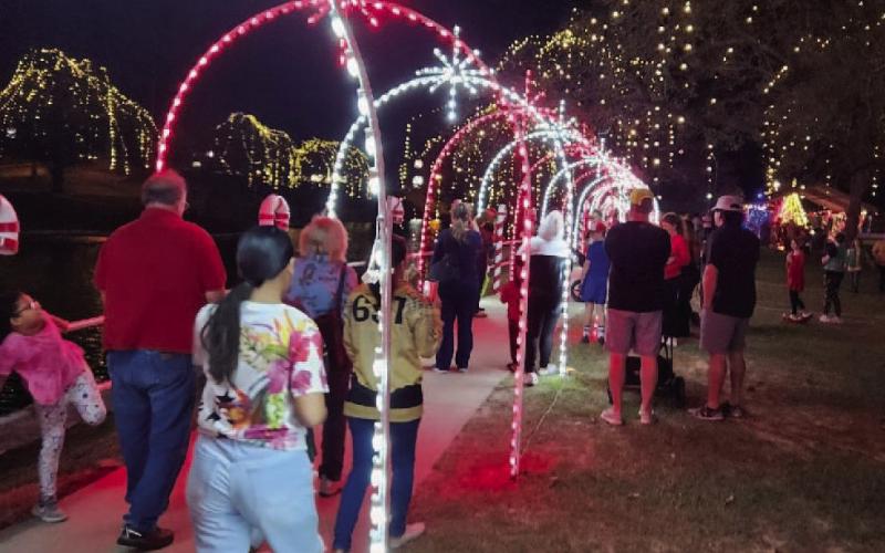 Throngs of Lampasans strolled through Candy Cane Lane at W.M. Brook Park on Saturday to view the holiday lights and festive decorations set up to celebrate the Christmas season. The Christmas on the Creek event offered rides on the Candy Cane Express, a visit with Santa and Mrs. Claus, and a stroll through the North Pole Village while sipping on hot chocolate. The special lights display will be available in the park through the New Year’s holiday. DAVID LOWE | DISPATCH RECORD