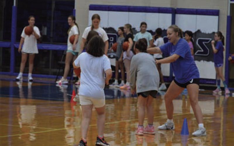 Lady Badger Kennedi Smart helps future high school hoopers stay on track during Wednesday’s camp session. ERICK MITCHELL | DISPATCH RECORD
