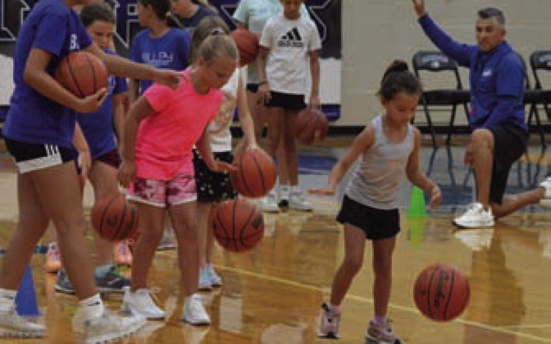 Campers practice their dribbling skills during Wednesday’s Lampasas High School girls’ basketball camp. ERICK MITCHELL | DISPATCH RECORD