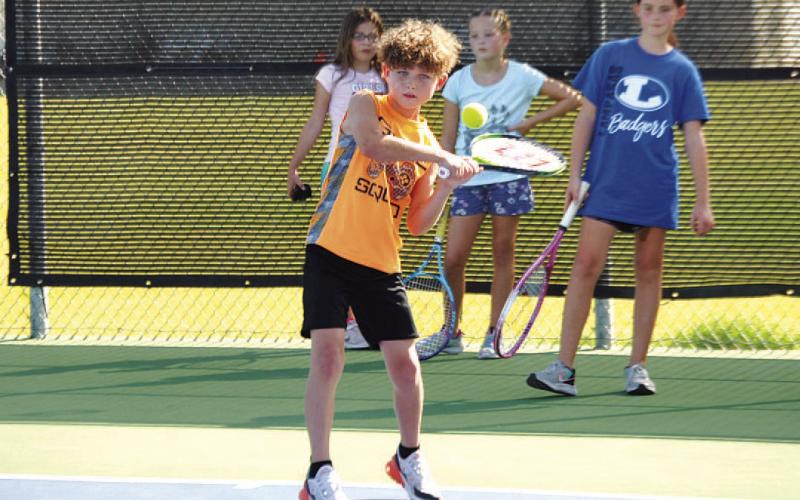 FILE PHOTO Kurt Hannabass works on a forehand shot during last summer’s tennis camp in July.