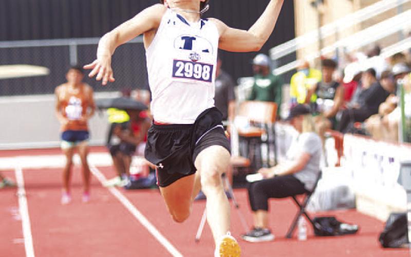 HUNTER KING | DISPATCH RECORD Asa White flies through the air during a jump attempt at the state track meet in Austin last Thursday.