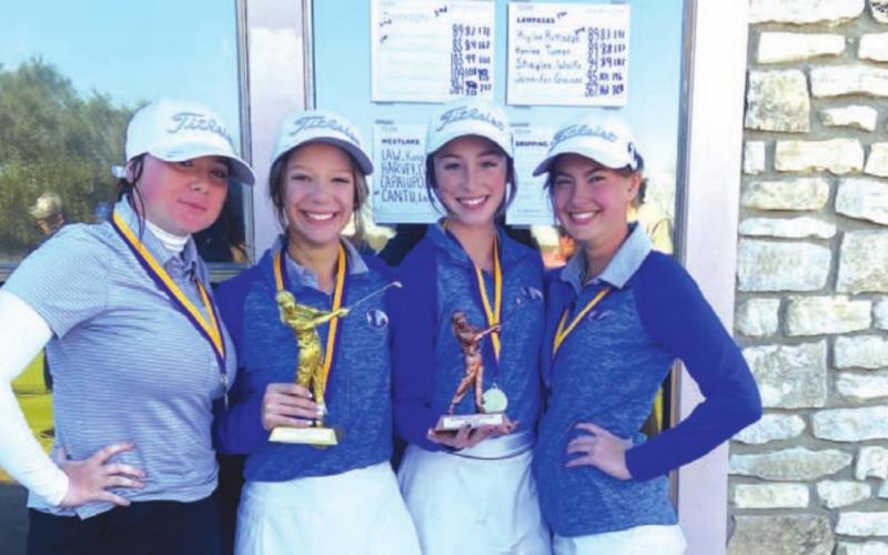 Jennifer Greiner, left, Kenlee Turner, Kylee Rutledge and Shaylee Wolfe pose for a photo with their trophy after winning in Marble Falls. COURTESY PHOTO