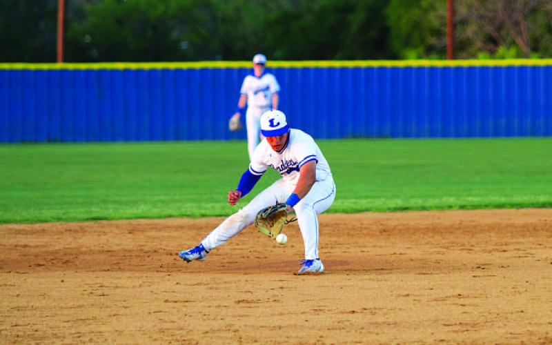 HUNTER KING | DISPATCH RECORD Elijah Calderon fields a ground ball on his backhand before throwing out a runner at first base.