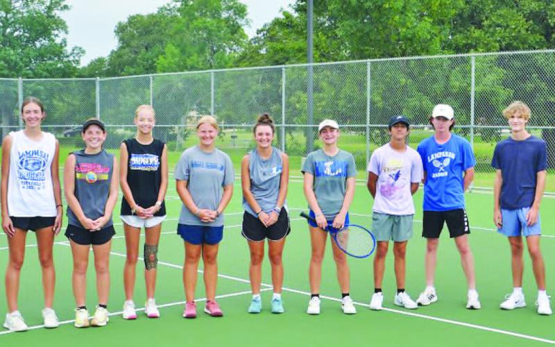 COURTESY PHOTO | KENNETH PEISER All 11 tennis players who made the trip to the regional tournament pose for a photo while in Bryan.