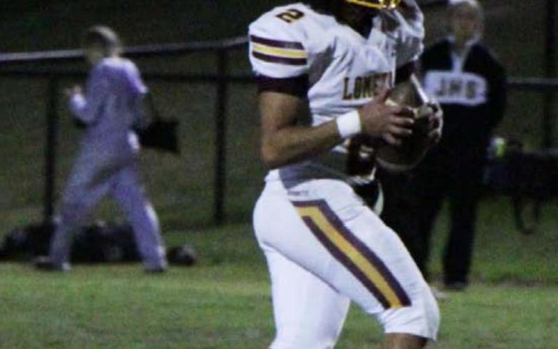 Tim Juarez looks downfield for a receiver while moving to his left against Jonesboro. JESSICA MALDONADO | DISPATCH RECORD