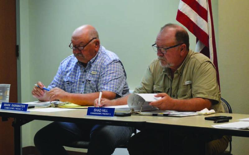 Commissioners Mark Rainwater, left, and Shad Hill review agenda materials at Monday’s Commissioners Court meeting, held at the county annex conference room. The next regular meeting will return to the courthouse’s first-floor courtroom. ERICK MITCHELL | DISPATCH RECORD