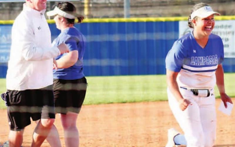 Teacher/coach John Rogers accompanies junior Mia Maldonado after high-fiving head softball coach Jessica Harborth at a teacher recognition event before the game against Gatesville. Players were introduced along with selected teachers in a pregame ceremony. CHRIS YBARRA | DISPATCH RECORD