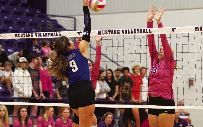 HUNTER KING | DISPATCH RECORD Lilee Hamill spikes the ball past the Marble Falls block attempt for a kill.
