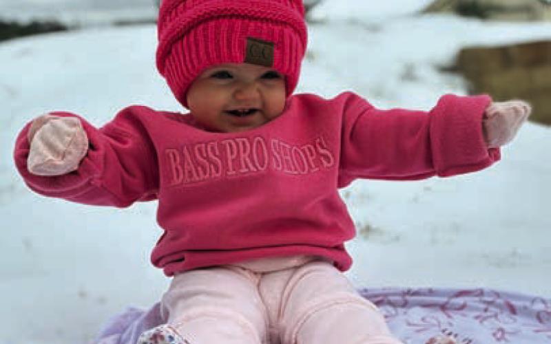 Ten-month old Kyra Kennedy enjoys her first time in the snow. CARLEY ROBERTS | COURTESY PHOTO