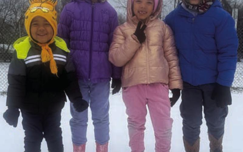 From left, Yacoby, Silver, Orchid and RaNour Davis bundle up before partaking in sledding activities on College Street. KAYLA RODRIGUEZ | COURTESY PHOTO