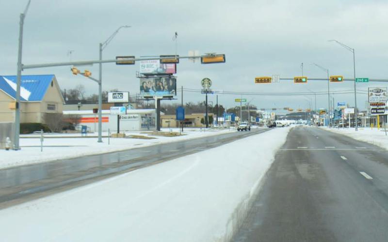 Key Avenue was sparsely traveled early Sunday morning. Thick snow lines the streets and fills the center turn lane, contrasted with clear north- and southbound lanes which crews had treated to enable driving. COURTESY PHOTO