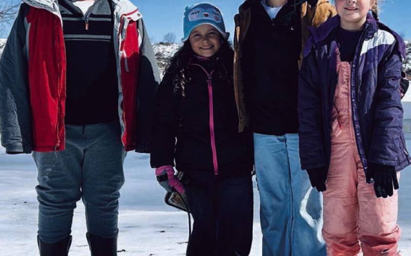 From left, Bradley Milam, Lydia Delgado, Audrey Delgado and Katy Milam pose for a quick photo before sledding action. NANCY MILAM | COURTESY PHOTO