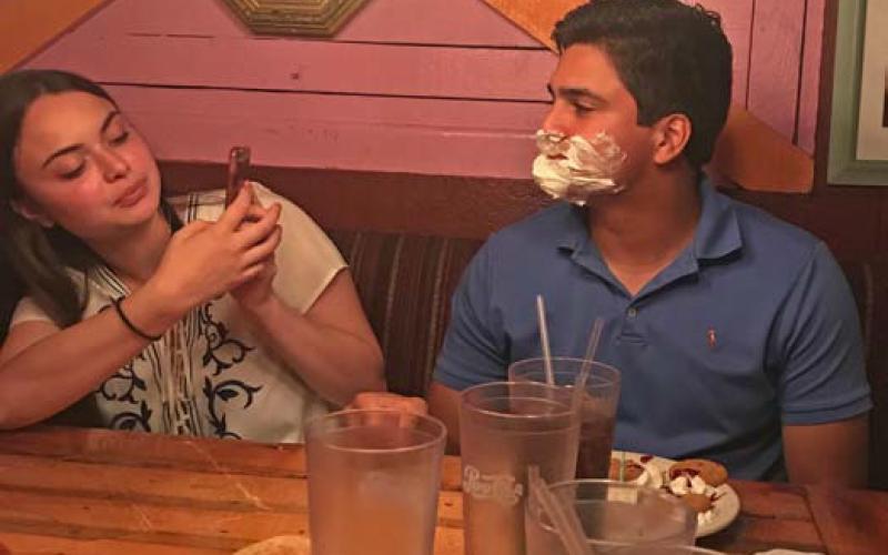 In 2018, after Erick Mitchell’s parents told the Magic Time Machine server it was his birthday, crew members serenaded him before covering his face in whipped cream. Mitchell’s wife, Emma, tries to capitalize on the moment with a photograph. courtesy photo