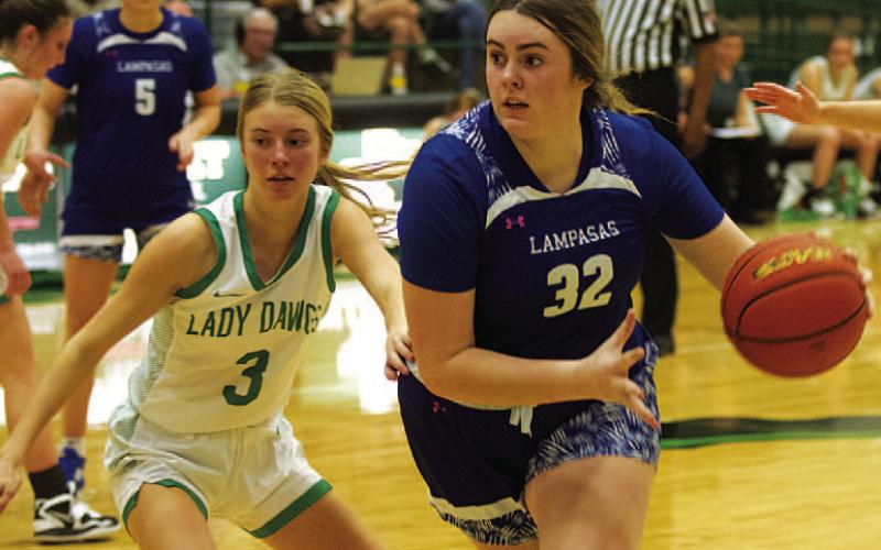 Abigail Williams dribbles past the Lady Dawgs defender to the basket. HUNTER KING | DISPATCH RECORD