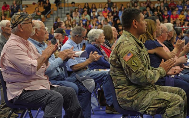 Veterans give a round of applause during Lampasas Middle School’s 21st annual Veterans Day program on Thursday. ERICK MITCHELL | DISPATCH RECORD