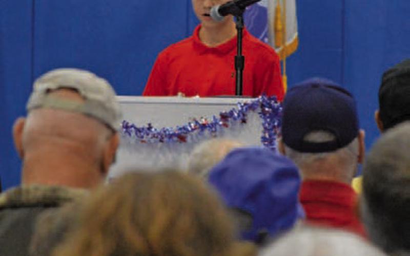 Eighth-grade student Brazos Andrews reads his essay to those gathered for Lampasas Middle School’s annual Veterans Day program. ERICK MITCHELL | DISPATCH RECORD
