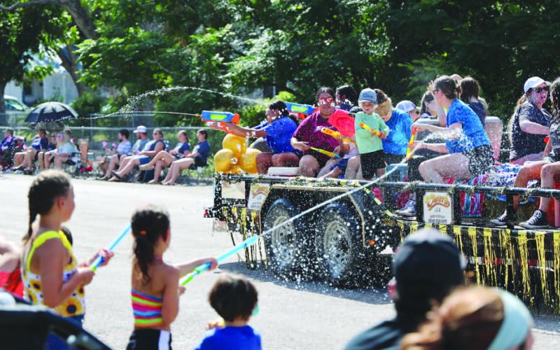 As is the tradition, Spring Ho Parade participants on floats and in the procession engage in a spirited water battle with the crowd. JOYCESARAH MCCABE | DISPATCH RECORD