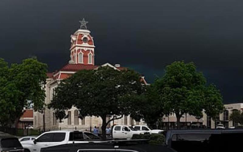 Storm clouds hover over downtown square on stormy Monday