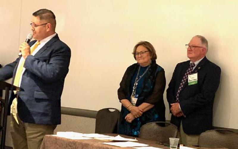 Pictured from left to right are T.J. Verver, Farm Bureau field director, who introduced Lampasas County Farm Bureau member and outgoing TFB Director Mickey Edwards and his wife Janie at the District 8 Caucus held during the annual Texas Farm Bureau state conference in Round Rock. courtesy photo