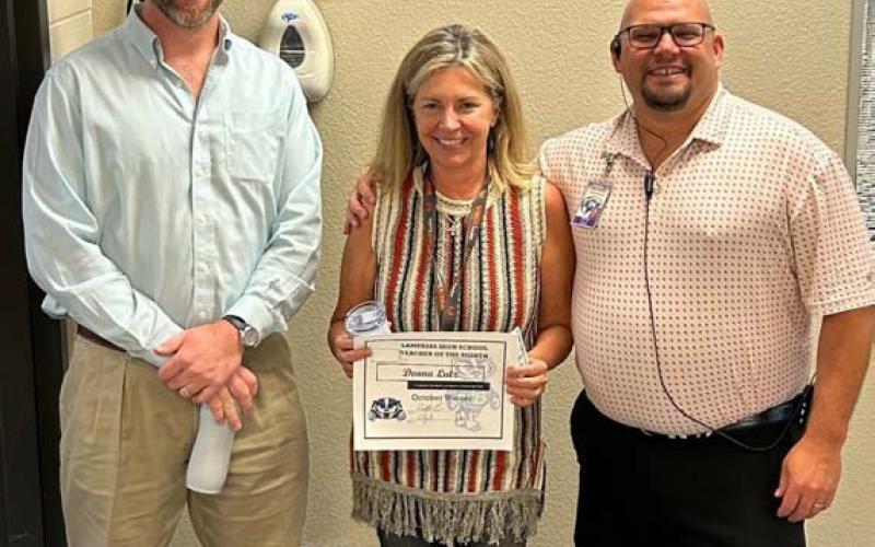 courtesy photo Teacher of the Month honors for October go to Donna Lutz, a special education instructor at Lampasas High School. She is pictured with Clay Phillips, left, of Texas Farm Bureau Insurance and Assistant Principal Ryan Race, who said of Lutz: “She has a huge heart and pours her soul into the job.”